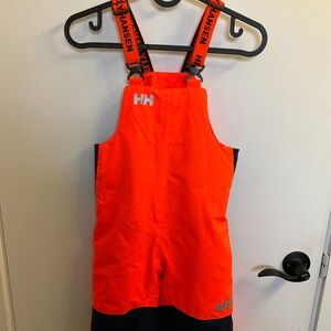 Insulated ski bib pants by Helly Hansen in bright orange - size 104/4